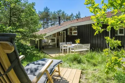 a patio with a table and chairs in front of a house at BL1636-Saltum-Saltum-Strandvej-140 in Saltum