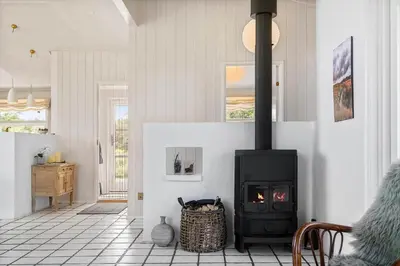 a living room with a stove in a room at BL1243-Saltum-Kvansletten-22 in Saltum