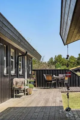 a deck with a table and chairs on a house at BL1243-Saltum-Kvansletten-22 in Saltum