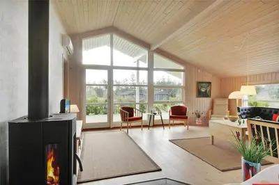 a living room with a fireplace and a couch at BL1299-Saltum-Bondagervej-44 in Saltum