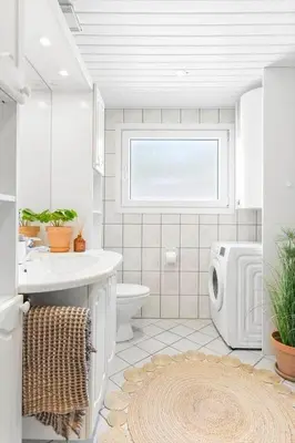 a bathroom with a toilet and a sink and a window at BL1668-Blokhus-Skraavejen-4 in Blokhus