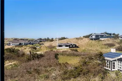 a group of houses with solar panels on a hill at BL971-Blokhus-Slugten-10 in Blokhus