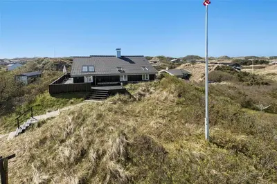 a house sitting on top of a hill at BL971-Blokhus-Slugten-10 in Blokhus