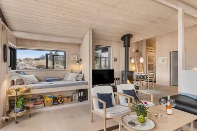 a room with a bed and a living room at BL842-Blokhus-Laerkevej-29 in Blokhus