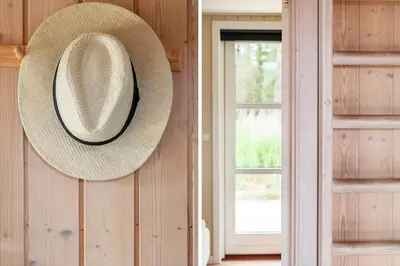 a straw hat hanging on a wall next to a window at BL1399-Saltum-Laustvej-30 in Saltum