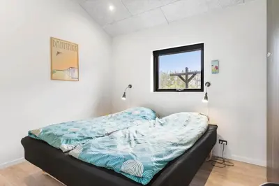 a bedroom with a bed in a room with a window at BL200-Saltum-Laustvej-9 in Saltum