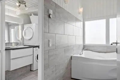 a bathroom with a sink and a washing machine at BL1486-Saltum-Ornebjergvej-4 in Saltum