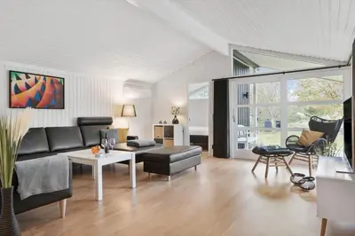 a living room with a couch and a table at BL1713-Blokhus-Ingersvej-8 in Blokhus