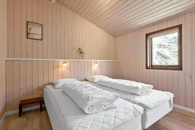 a bedroom with two beds with white sheets and a window at BL1311-Saltum-Kordalsvej-90 in Saltum