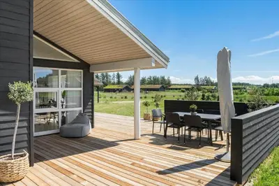 a wooden deck with a table and chairs on it at BL479-Saltum-Laustvej-26 in Saltum