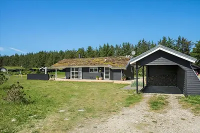 a house with a garage in front of a yard at BL479-Saltum-Laustvej-26 in Saltum