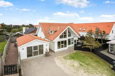 an aerial view of a white house with an orange roof at BL1567-Blokhus-Klitvejen-6 in Blokhus
