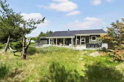 a green house with a yard with grass at BL1725-Saltum-Sonderborgvej-17 in Saltum