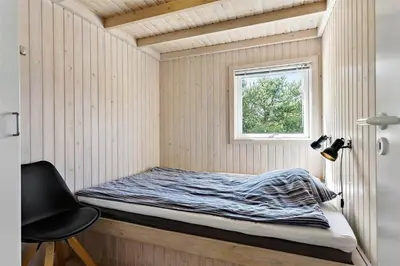 a small bed in a room with a window at BL1725-Saltum-Sonderborgvej-17 in Saltum