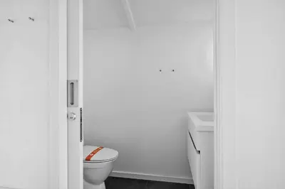 a white bathroom with a toilet and a sink at BL1236-Pandrup-Kirkekrogen-5 in Pandrup