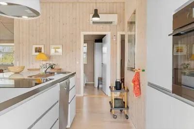 a kitchen with white countertops and a hallway at BL448-Saltum-Nordvestvej-1 in Saltum
