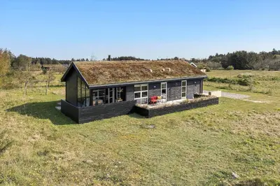 a small house sitting in a field of grass at BL448-Saltum-Nordvestvej-1 in Saltum