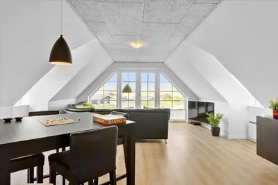 a living room with a dining room table and chairs at BL854-Saltum-Porsevej-6-A in Saltum