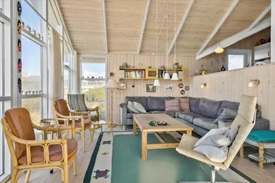 a living room with a blue couch and chairs at BL1747-Blokhus-Norresundbyvej-22 in Blokhus