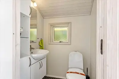 a bathroom with a toilet and a sink at BL410-Saltum-Store-Fiskerbanke-4 in Saltum