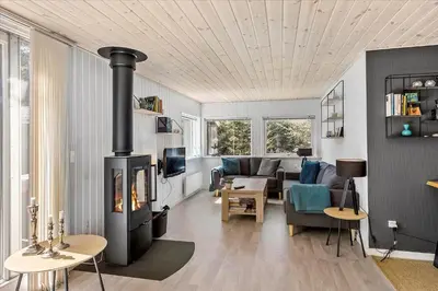a living room with a fireplace and a couch at BL1417-Blokhus-Frederiksensvej-16 in Blokhus