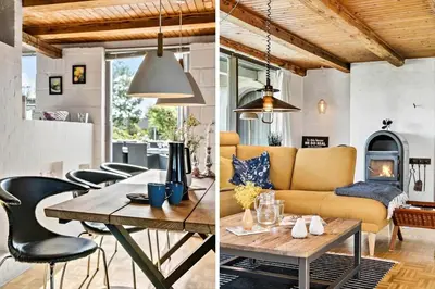 a living room and a dining room with a couch and a table at BL1549-Blokhus-Bakkevaenget-11 in Blokhus