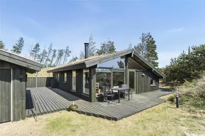 a house with a deck with a dining table at BL1522-Saltum-Kordalslien-25 in Saltum