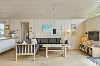 a living room with a couch and a table at BL1522-Saltum-Kordalslien-25 in Saltum