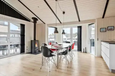 a kitchen and dining room with a table and chairs at BL239-Blokhus-Klitgaardsvej-21 in Blokhus