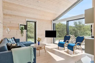 a living room with a couch and chairs and a tv at BL1464-Saltum-Nordvestvej-34 in Saltum
