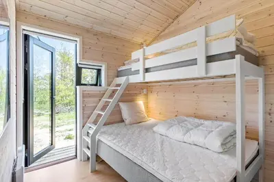 a bedroom with bunk beds in a wooden house at BL1464-Saltum-Nordvestvej-34 in Saltum