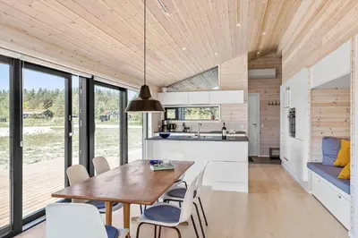 a kitchen and dining room with a table and chairs at BL1464-Saltum-Nordvestvej-34 in Saltum
