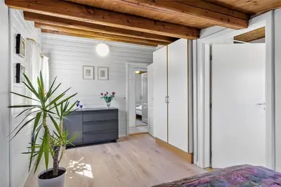 a bathroom with white walls and a wooden ceiling at BL141-Blokhus-Vigen-12 in Blokhus
