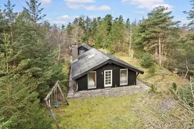 a small house in the middle of a forest at BL353-Blokhus-Kragebak-1 in Blokhus