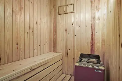 a corner of a wooden cabin with a stove in it at BL1051-Pandrup-Rodhus-Skolevej-11 in Pandrup