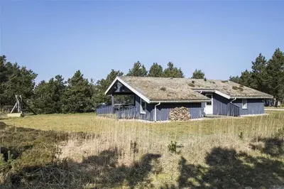 an old house with a grass roof on a field at BL1051-Pandrup-Rodhus-Skolevej-11 in Pandrup
