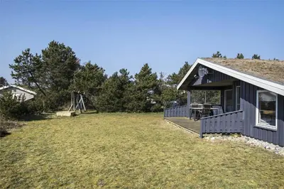 a house with a large yard with a playground at BL1051-Pandrup-Rodhus-Skolevej-11 in Pandrup