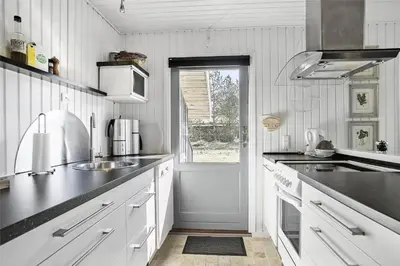 a white kitchen with a sink and a window at BL1051-Pandrup-Rodhus-Skolevej-11 in Pandrup