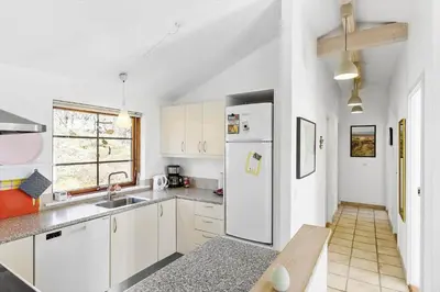 a kitchen with white cabinets and a white refrigerator at BL245-Pandrup-Bremersvej-4 in Pandrup