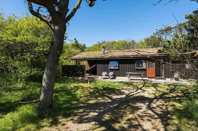 a log cabin with a tree in front of it at BL245-Pandrup-Bremersvej-4 in Pandrup