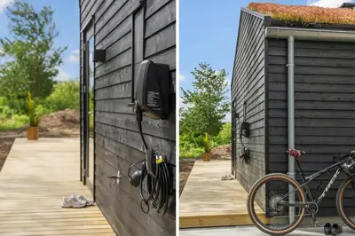 a bike parked next to a wall with a pay phone at BL1465-Blokhus-Bag-Hojen-8-c in Blokhus