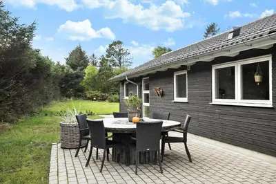a table and chairs sitting on a patio at BL1785-Blokhus-Jaegerensvej-18 in Blokhus