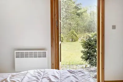 a bedroom with an open door to a window at BL1553-Pandrup-Lunekrogen-9 in Pandrup