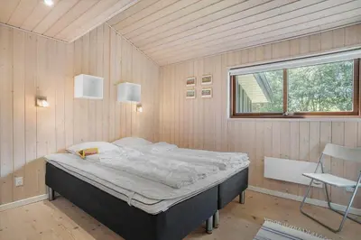 a bedroom with a bed in a room with a window at BL455-Pandrup-Rodhus-Skolevej-52 in Pandrup