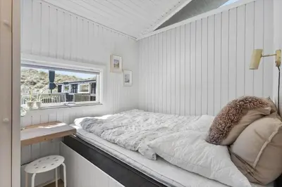 a white room with a bed and a window at BL1383-Saltum-Foraarsvangen-18 in Saltum