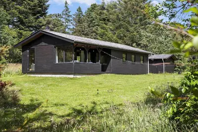 a small house in a field with a grass yard at BL1208-Saltum-Tippen-10 in Saltum