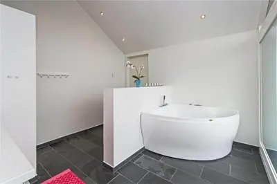 a bathroom with a white tub and a sink at BL655-Blokhus-Sdr-Strandvej-11 in Blokhus