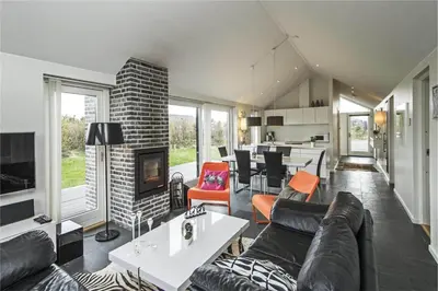 a living room with a couch and a fireplace at BL655-Blokhus-Sdr-Strandvej-11 in Blokhus