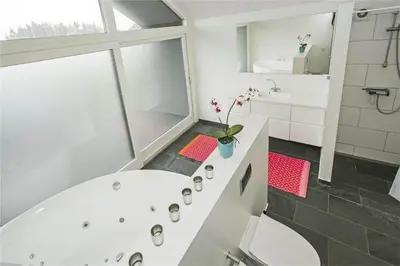 a bathroom with a white tub and a sink at BL655-Blokhus-Sdr-Strandvej-11 in Blokhus