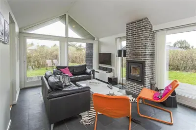 a living room with a couch and a fireplace at BL655-Blokhus-Sdr-Strandvej-11 in Blokhus